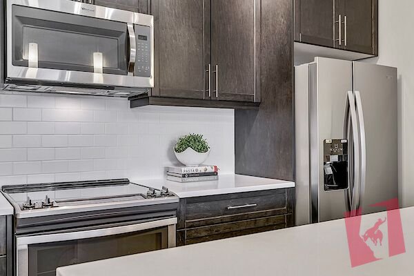 New condition top floor 1 bedroom and den with underground parking and storage.