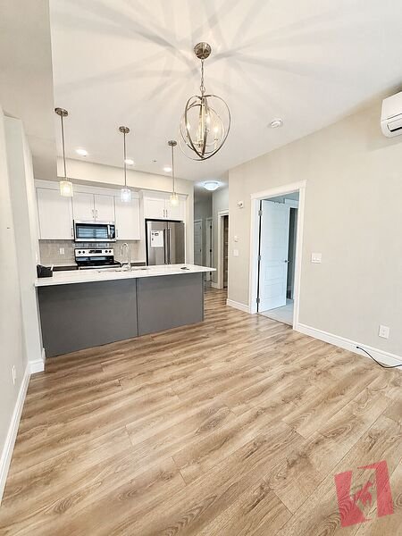 Bright & Spacious TOP FLOOR (Air conditioned) 1-Bedroom + Den Condo