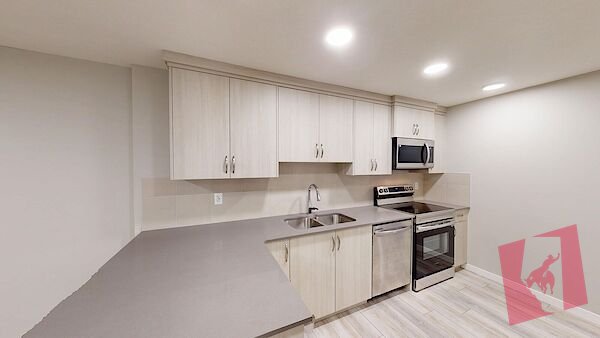 Cozy 2-bedroom, 1-bath legal basement suite in the vibrant new community of Rangeview! photo 3